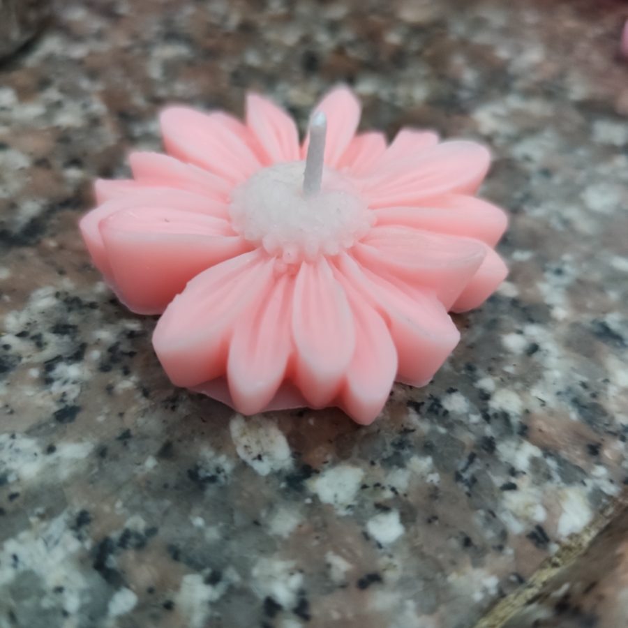 Pink daisy-shaped floating candle