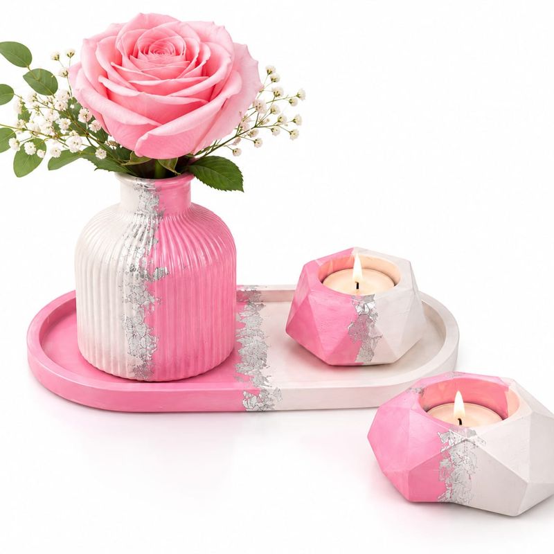 Pink and white ribbed vase with geometric tealight holders on an oval tray