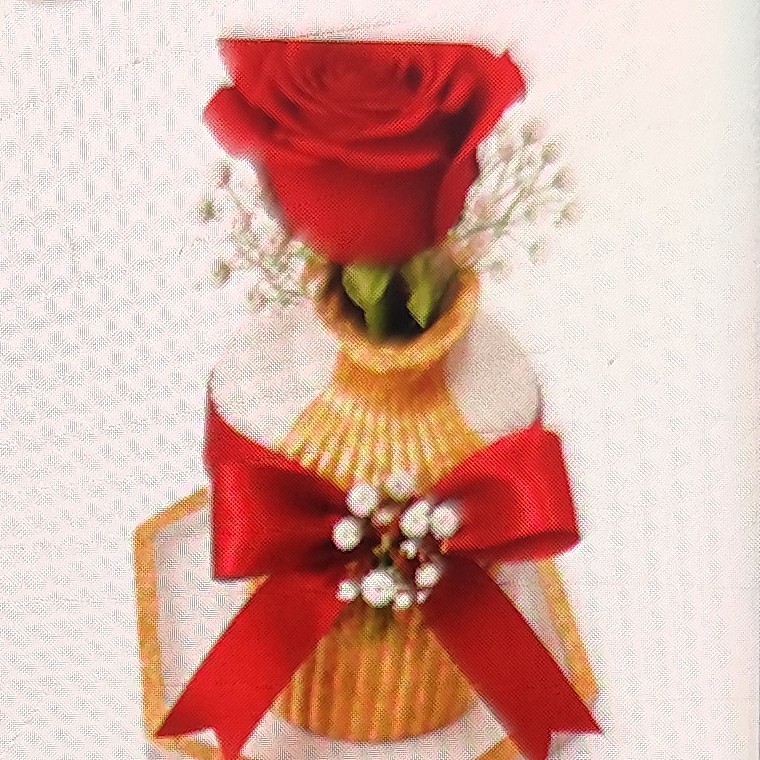 Gold ribbed vase with a red rose and red satin bow on a hexagon tray
