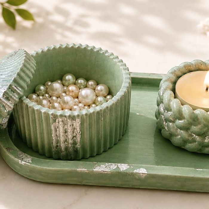 Sage green tray with a lidded trinket box and a braided tealight holder