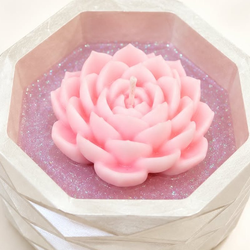 Pink lotus candle on shimmering lilac wax in a pearl-white faceted octagon jar